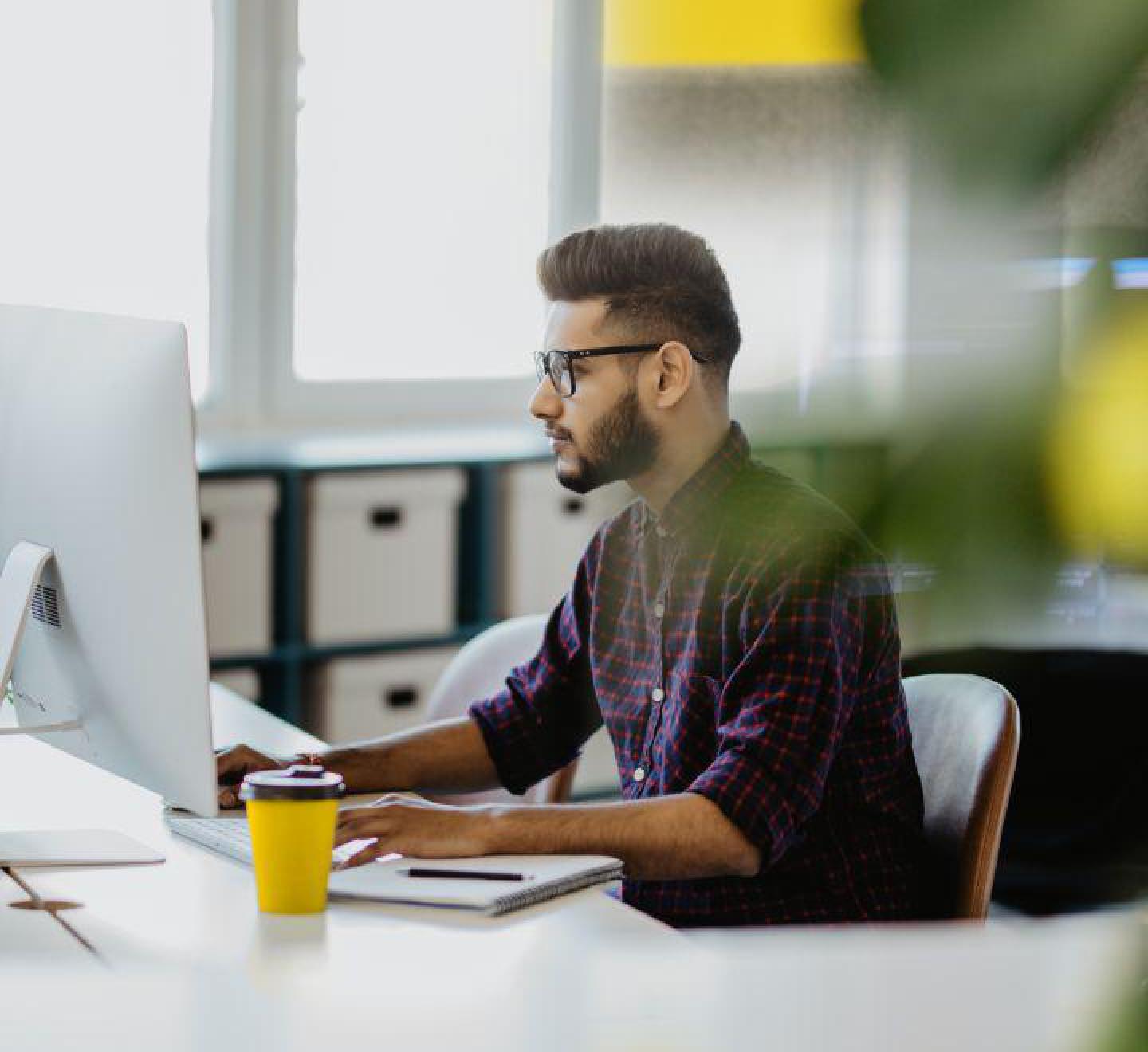 One of our friendly staff providing call answering assistance whilst looking at his computer.