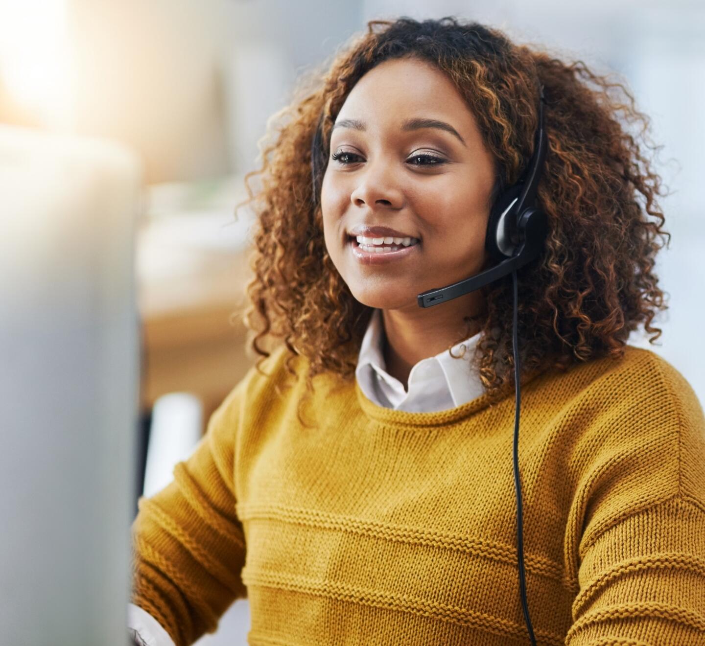 Woman contact centre operator using headset