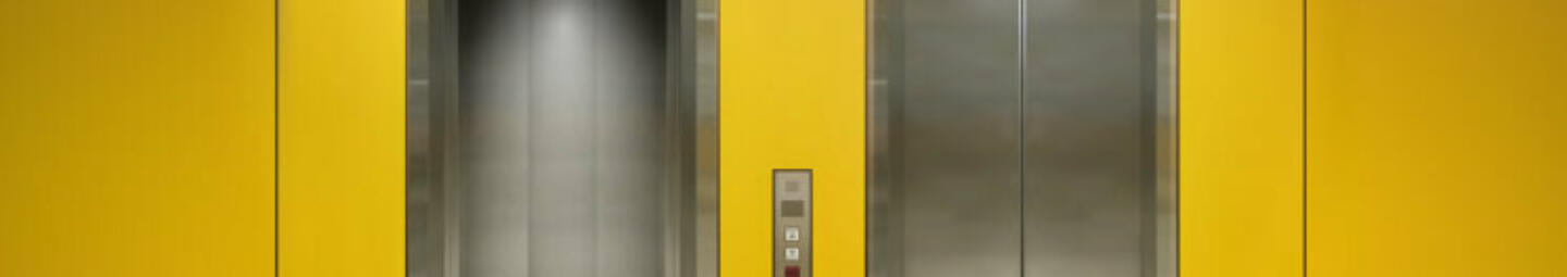 Two lift entrances on yellow wall