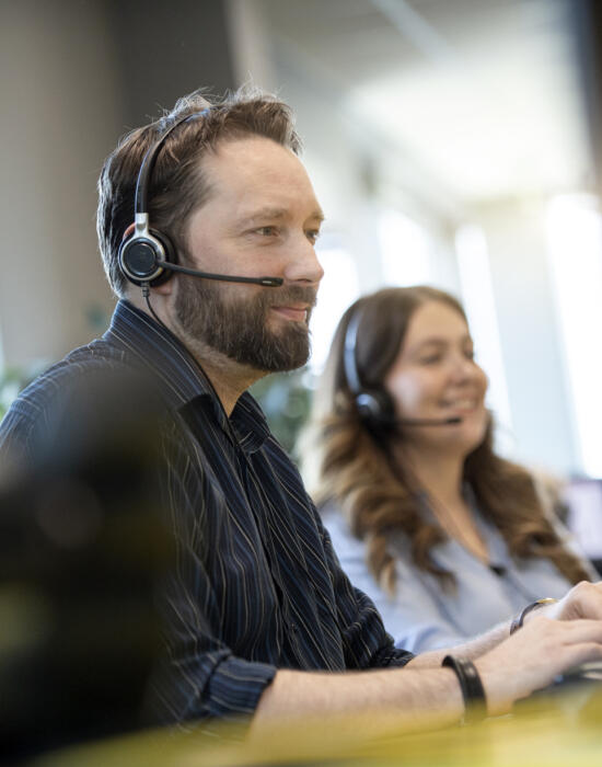Two Lemon Contact Centre operators taking calls wearing headsets