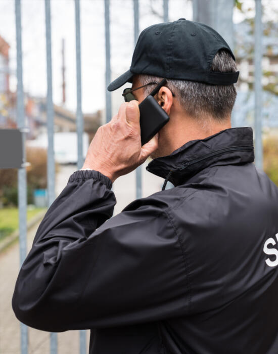 Security guard on the phone to contact centre operator