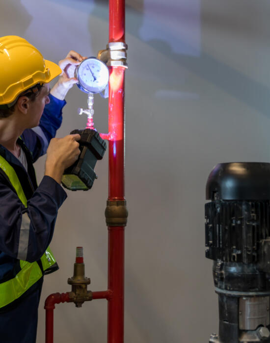 Fire sprinker maintenance engineer wearing yellow hat