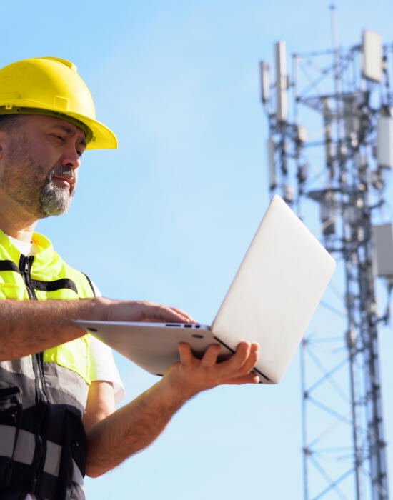 Telecoms engineer using laptop support