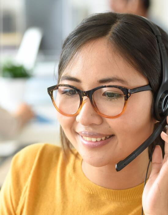 Contact centre operator on a call using headset