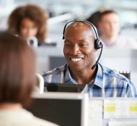 Contact centre operator smiling wearing headset