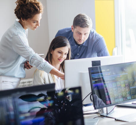 Professionals working together looking at computer