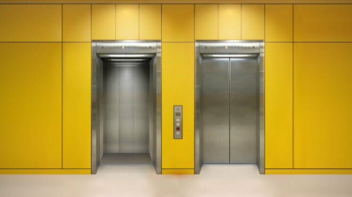 Two lift entrances on yellow wall