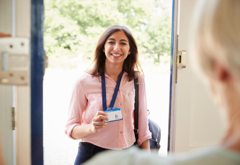 Healthcare worker showing badge to customer