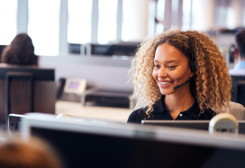 Smiling call centre agent with headset