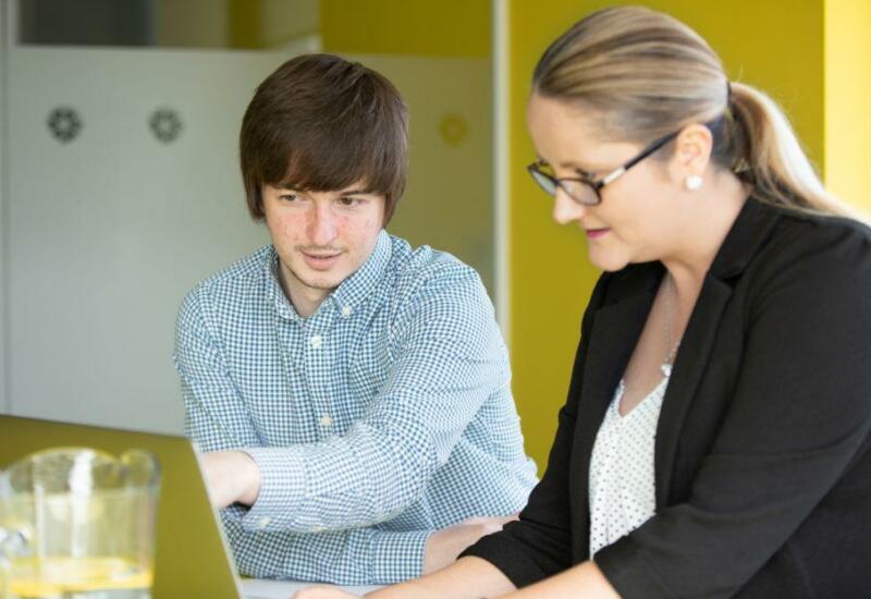 Two team members reviewing business processes