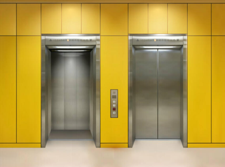 Two lift entrances on yellow wall