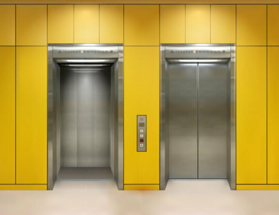 Two lift entrances on yellow wall